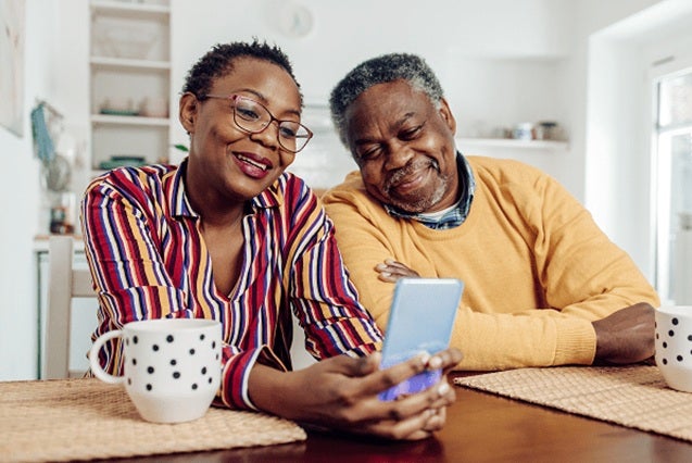 Senior couple using device