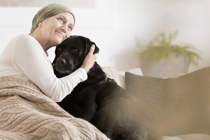 woman in hospice hugging dog