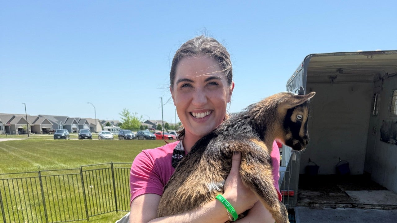 woman holding goat