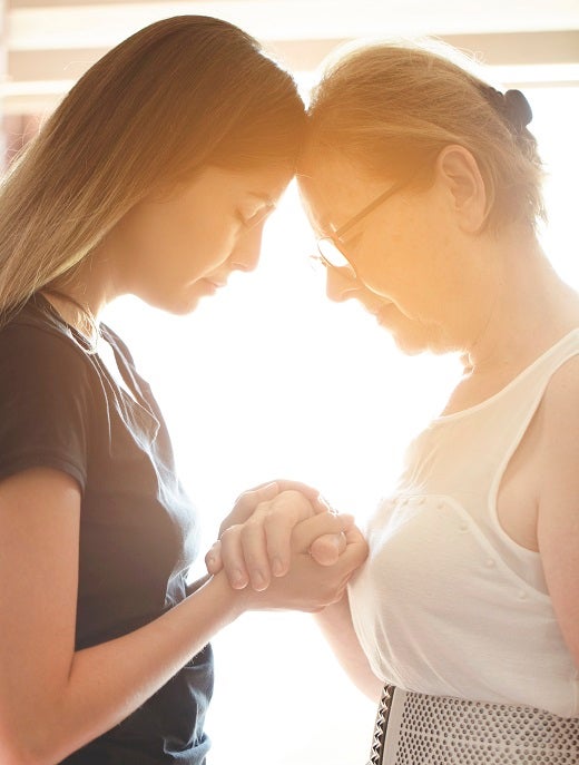 Mother and daughter praying